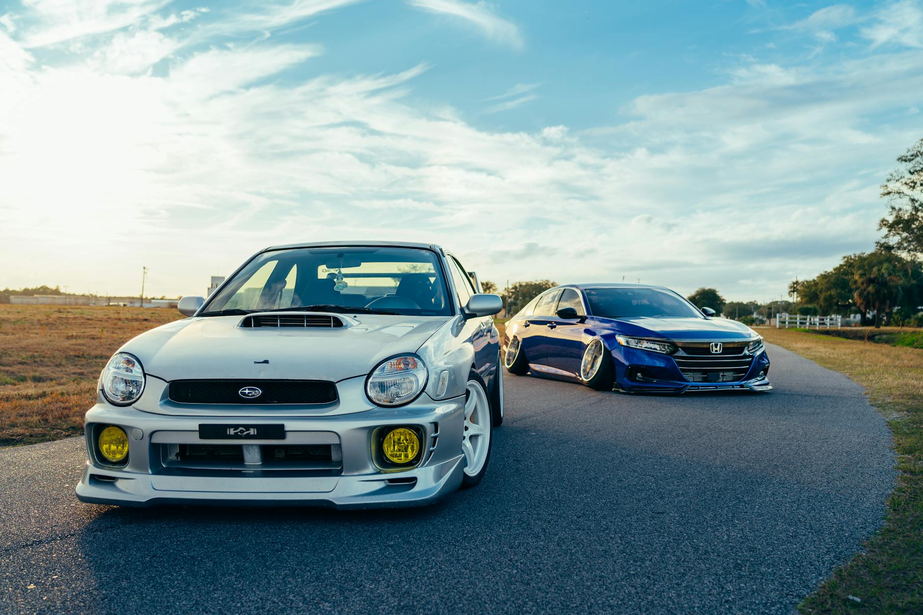 Stuningowane Ople zaparkowane na malowniczej drodze o zachodzie słońca